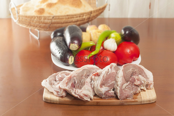 raw lamb meat with fresh vegetables