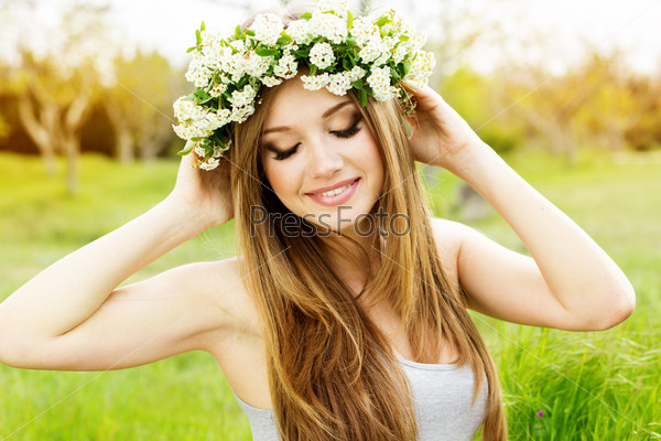 beautiful girl in wreath of flowers