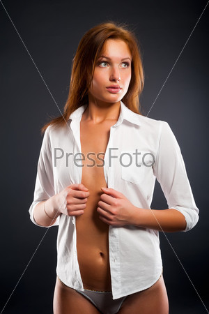 Portrait of sexy young woman at black background