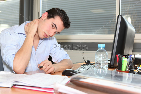 Young man tense at work