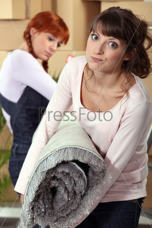 Women with a roll of carpet