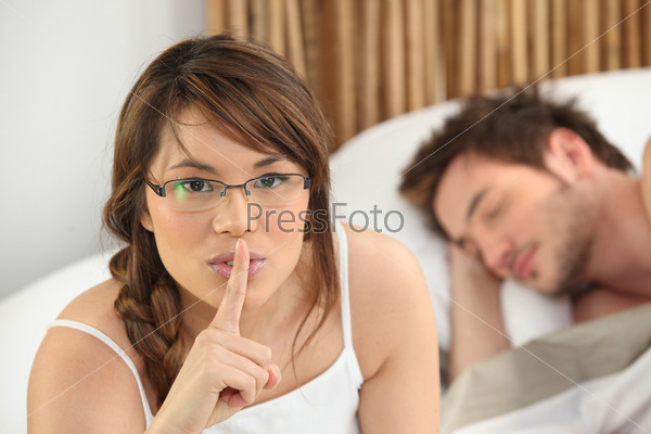 Woman sitting next to a sleeping man
