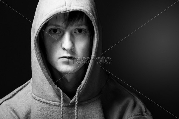 young man in green sweatshirt with turned up hood