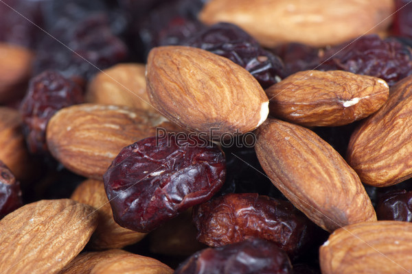 Dried cranberries in sugar with almonds close up