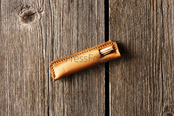 Handmade leather product over wooden background