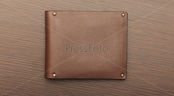 leather purse on wood background