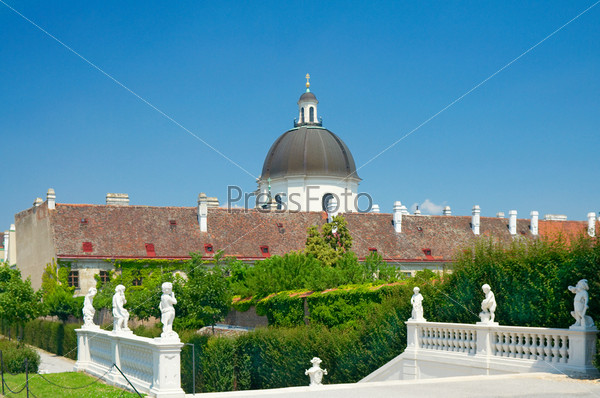 Gardens in Belvedere, Vienna, Austria. Behind the houses could be seen Church of the Order of the Visitation of Holy Mary