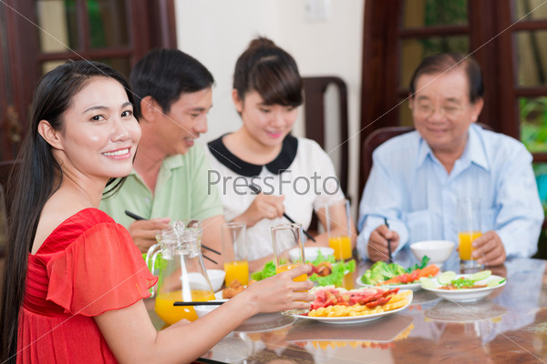 Portrait of a young asian lady at the dinner on the foreground