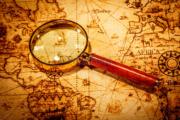 Vintage Still Life. Vintage Magnifying Glass Lies On An Ancient World Map