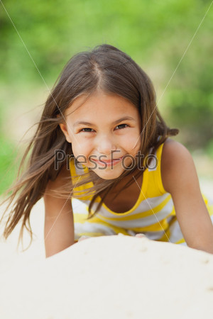 five-year-old girl lying on the beach