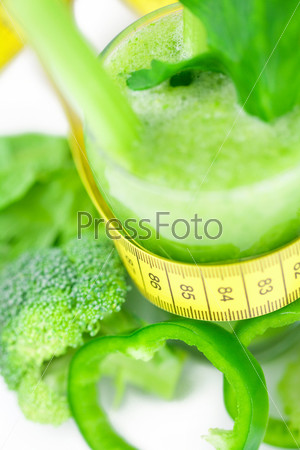 measuring tape,broccoli,pepper,celery and glass with celery juice isolated on white
