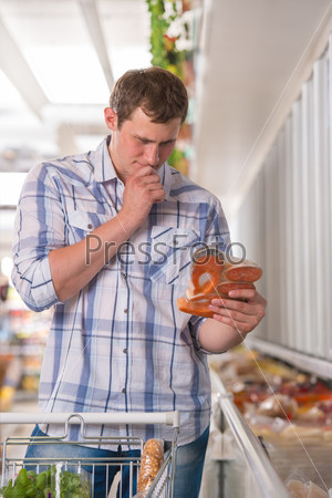 Man thinking about products at the supermarket