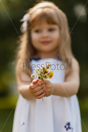 Girl with sunflower in summer field