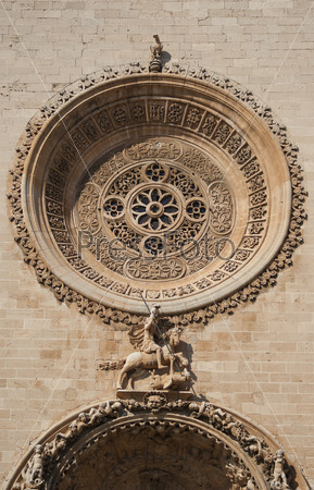 Saint George and the dragon - architectural detail at the facade of  Palma de Mallorca cathedral, Spain