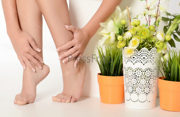 Female hands and feet with manicure and a pedicure