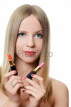 The beautiful girl with lipsticks in hands