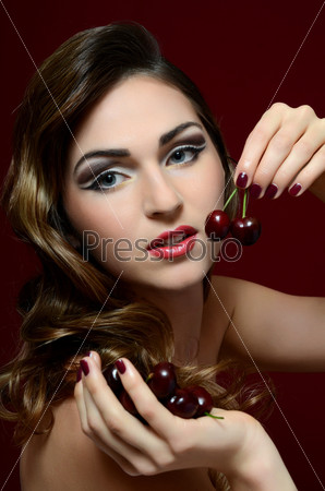 The beautiful woman with sweet cherry