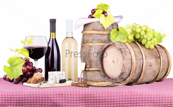 picnic lunch on a red and white gingham tablecloth including a wine,bread,cheese and grapes