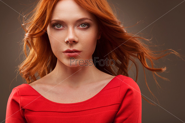 closep portrait of sexual woman wearing red dress over dark background