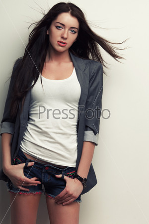 sexual woman fashion studio portrait with flying hair over white wall