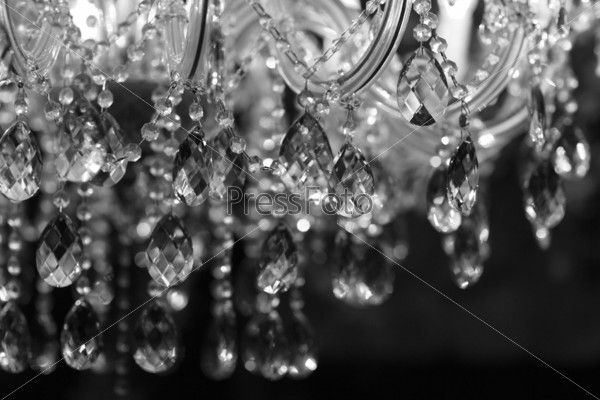 Chrystal chandelier close-up. Glamour black and white background with copy space