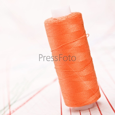Spool of thread. Sew accessories on blurred background