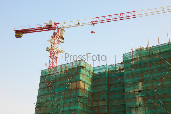 Construction of the building with a crane