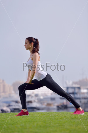 Young beautiful woman jogging and running on morning at park in the city. Woman in sport outdoors health and fitness concept, stock photo