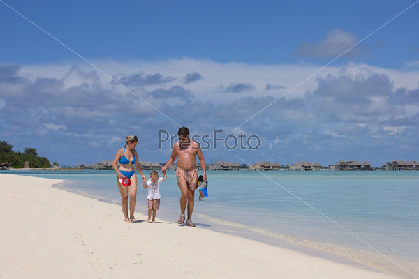 Portrait of a happy family on summer vacation at beach, stock photo