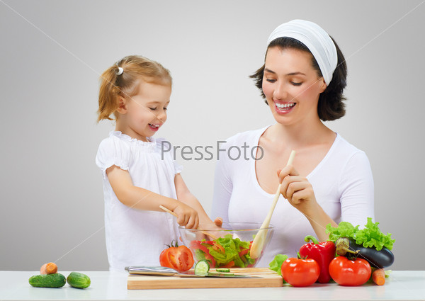 Mother and daughter prepare salads, stock photo