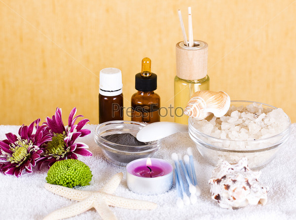 Two bottles of essence oil and chrysanthemum. Spa concept.