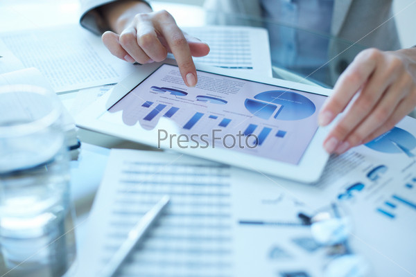 Hands of businesswoman working with electronic document in touchpad