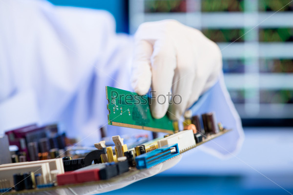 Cropped image of an engineer installing RAM card into the memory slot