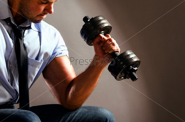 strong business man is raising a dumbbell