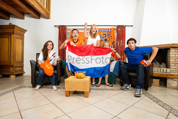 Soccer Fans Cheering While Watching Match At Home