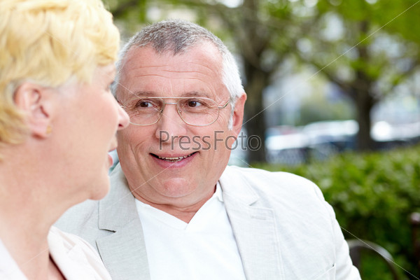 Mature woman and her husband having talk outside