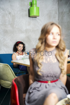 Young woman  on sofa read magazine on background
