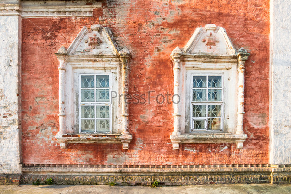 Facade of an old russian church with two windows
