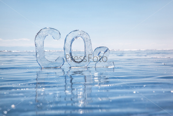 Chemical formula of greenhouse gas carbon dioxide CO2 made from ice on winter frozen lake Baikal under blue sky