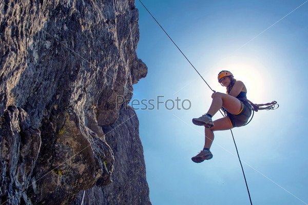 Abseiling woman
