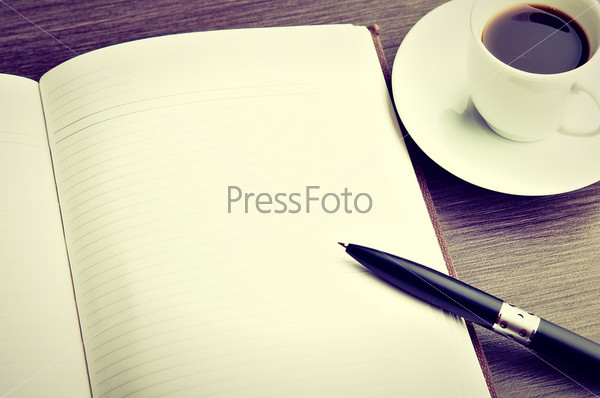 Open a blank white notebook, pen and cup of coffee on the desk