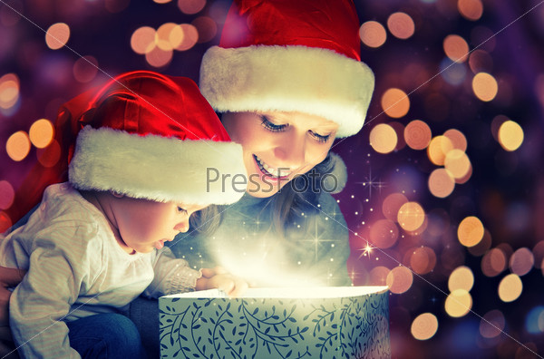 Christmas magic gift box and a woman happy family mother and Child baby, stock photo
