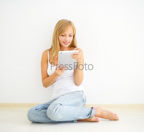 Young attractive girl with tablet pc. light background