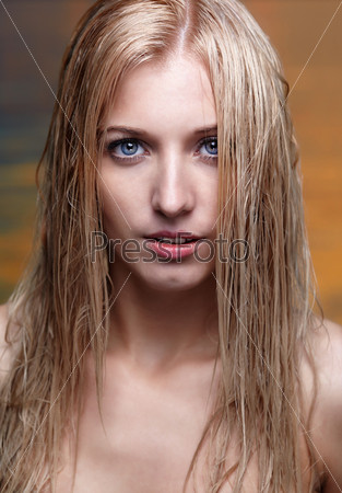 portrait of young beautiful blonde woman in bikini with wet hair. ocean on background