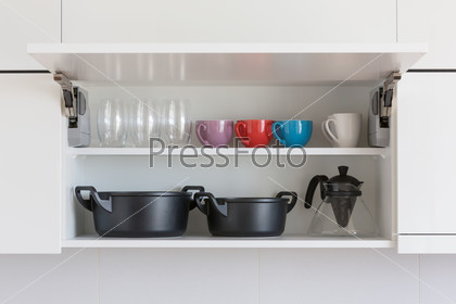 opened cupboard with kitchenware inside