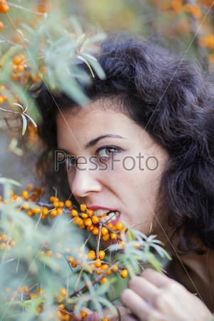 Zoomed view of woman bite gooseberries