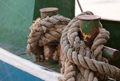 Rope tied to cleat on dock, closeup, stock photo