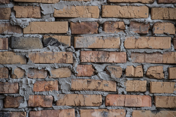Background based on the brickwork of the cracked and weathered stained rough brick. Art edition. Natural photorealistic brick.