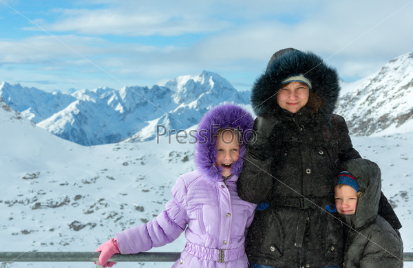 Family on ski station top and morning winter mountain landscape. Ski resort Molltaler Gletscher, Carinthia, Austria.