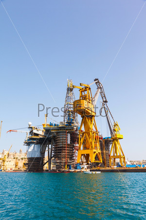 Oil platform repair Shipyards harbor of Malta in clear weather on a background of blue sky